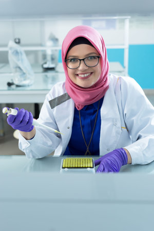 muslim lab worker with hijab or researcher doing an analysis in labaratory