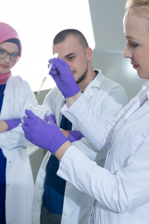Group of scientists working at the laboratoryの写真素材