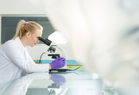 Young pretty girl in the modern laboratoryの写真素材