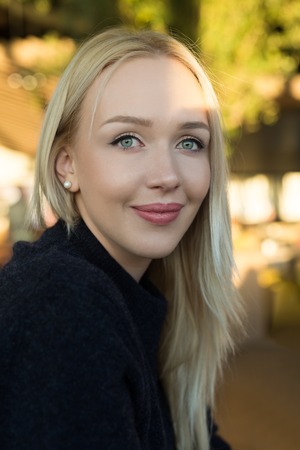 Beautiful young woman is looking at camera and smilingの写真素材
