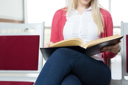student preparing exam and learning lessons in school library, making researchの写真素材