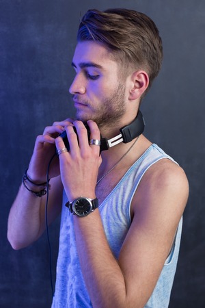 Portrait of young fashion man with headphonesの写真素材