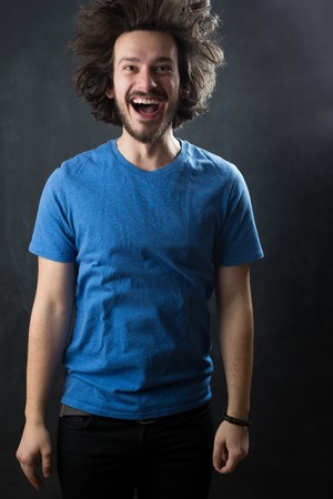 Portrait of a fashionable young man on dark background, chalkboard copyspaceのeditorial素材