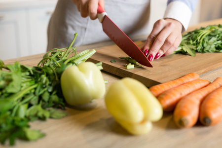 Young Woman Cooking in the kitchen. Healthy Food - Vegetable Salad. Diet. Dieting Concept. Healthy...