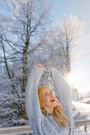 Woman in winter hat, winter. Portrait of attractive young girl in knitted clothes. sunny winter dayの写真素材