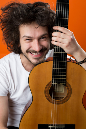 Portrait of a young man with guitarの写真素材