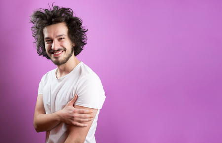 Beautiful caucasian man with funny hair over color background with copyspaceの写真素材