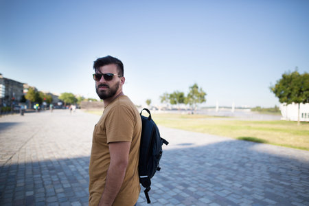 Handsome black bearded man as a tourist exploring the city. Portrait of a european handsome man.