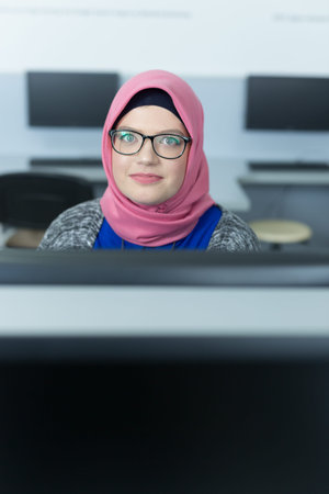 Woman with hijab working in a call center.