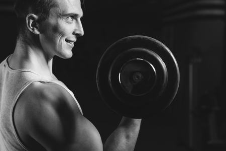 Closeup portrait of a muscular man workout with barbell at gym.  Deadlift barbells workout.の写真素材