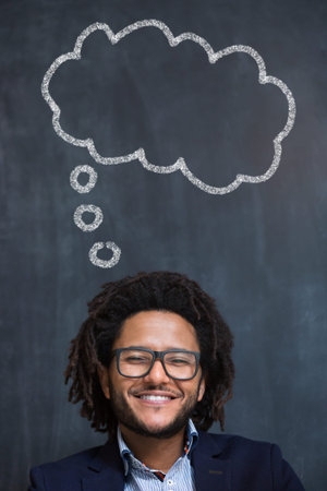 Young man against the background of chalkboard thinking about something