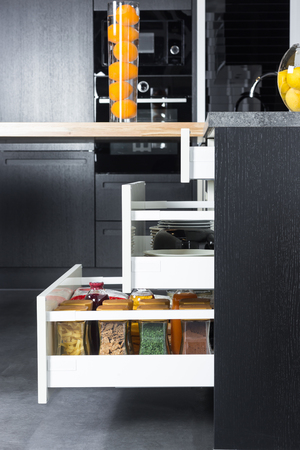 Side view of a spices and groceries organized in a modern kitchen drawer. Kitchen design inspiration.の写真素材