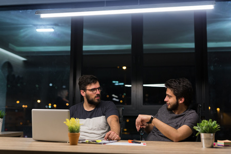 Young manager listening to his colleague explanationsの写真素材
