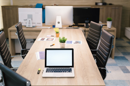 Close up Laptop Computer on Top of Office Table of a Businessman with Empty White Screen, Emphasizing Copy Space.の写真素材