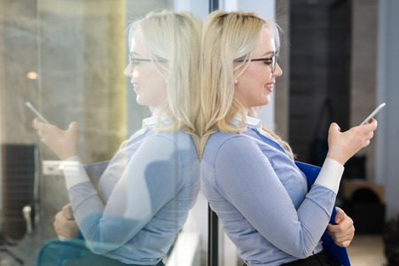 Young businesswoman talking on the mobile phoneの写真素材