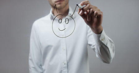 Devil emoji drawn , Man Writing on Glassの写真素材