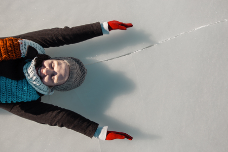 woman enjoying beautiful day on frozen lakeの写真素材