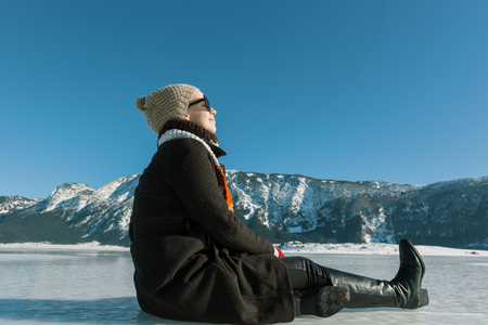 woman enjoying beautiful day on frozen lakeのeditorial素材