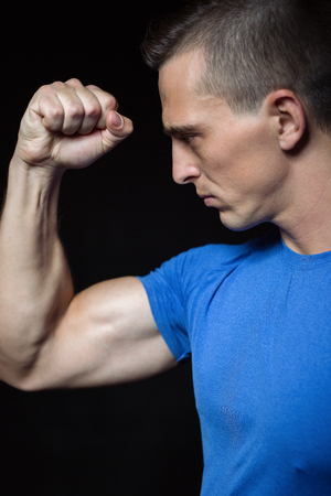 Portrait of a handsome athletic man with perfect muscular body over black background. Bodybuilding concept. Healthy lifestyle.の写真素材