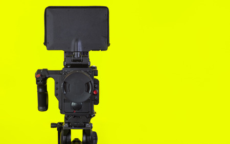 Professional video camera on vivid color background making contrastの写真素材