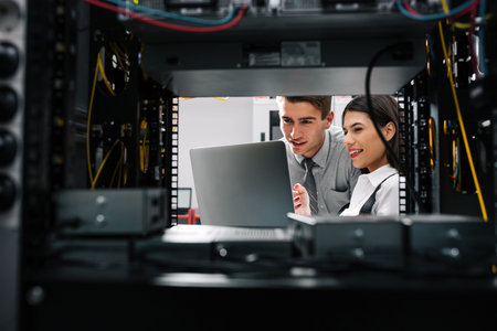 Team of technicians working together on servers at the data centre