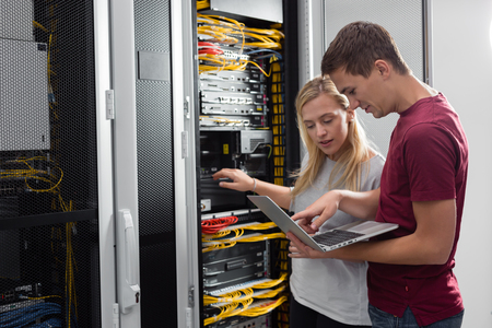 Team of technicians working together on servers at the data centreの写真素材