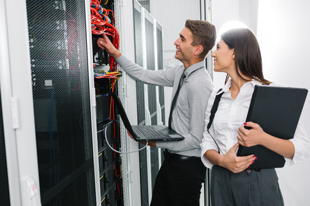 Team of technicians working together on servers at the data centreの写真素材