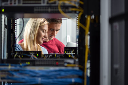 Team of technicians working together on servers at the data centre