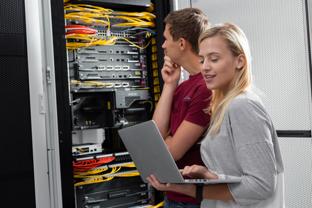 Team of technicians working together on servers at the data centreの写真素材