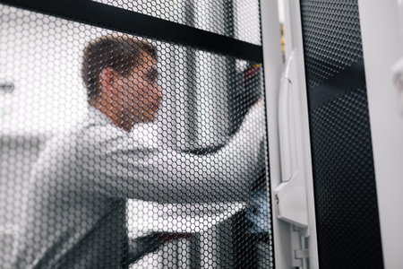 Man fix server network in data center room .