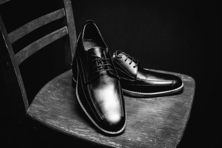 Black man's shoes on wooden chairの写真素材