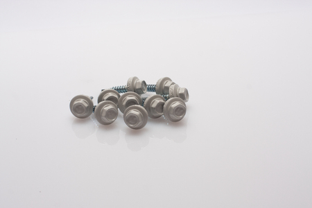 neatly arranged screws in a rowの写真素材