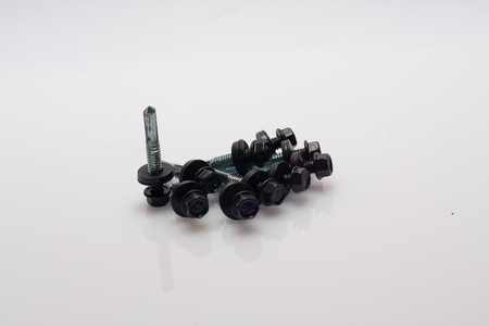 neatly arranged screws in a rowの写真素材
