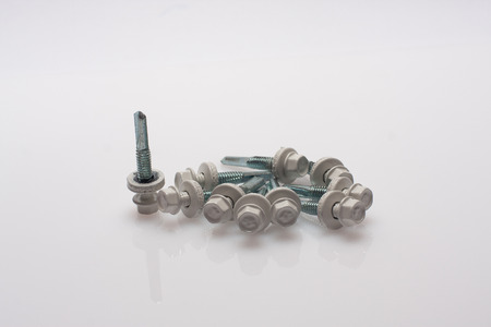 neatly arranged screws in a rowの写真素材