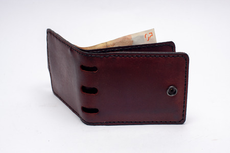 Brown wallet with money isolated on white backgroundの写真素材