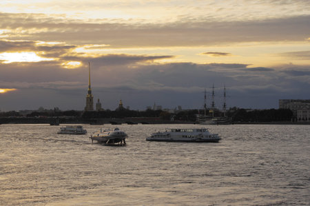 View of the Neva River and the with tourists boats and recognizable landmarks in background at...