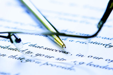Business letter with glasses and pen.