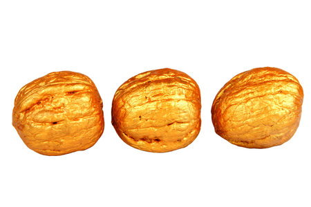 Isolated three various golden walnuts.