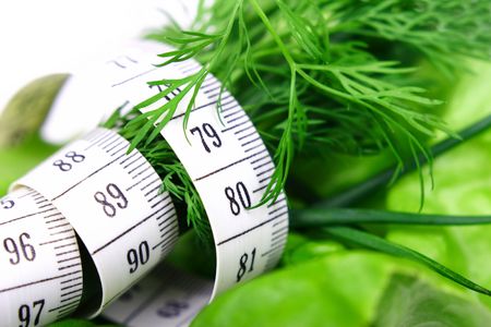 Green diet. Vegetables: lettuce, leaves, dill and chives with tape-measure.の写真素材