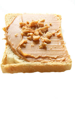 Slice of bread with peanut butter. Peanut butter is excellent addition for sandwiches and desserts.の写真素材