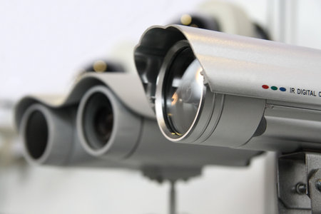 CCTV security cams on white wall background.