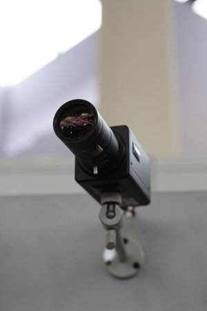 CCTV security camera on light background.