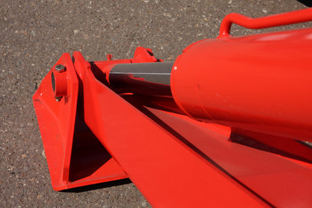 Folding hydraulic support on asphalt.