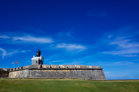 Castillo San Felipe del Morro and tower in San Juan, Puerto Rico against blue sky and green lawnのeditorial素材