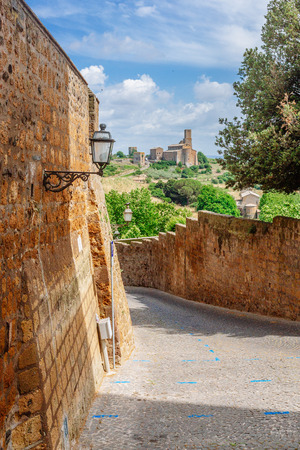 Road and church in the town of Tuscania, Italyの写真素材