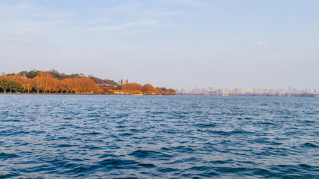 View of West Lake with city skyline of Hangzhou, China in the distanceの写真素材