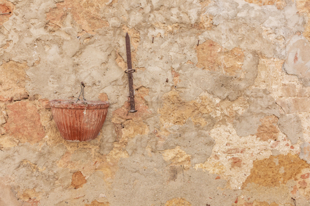 Old Italian Renaissance wall texture with flower pot and iron barの写真素材