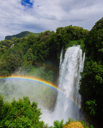 View of a rainbow over the Marmore Falls, the tallest man-made waterfall in the world, in Umbria,...