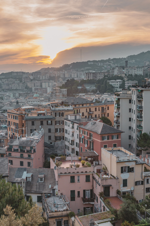 View of houses on hills under sunset in Genoa, Italyの写真素材