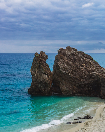 Two huge rocks by beach of Monterosso, Cinque Terre, Italyの写真素材